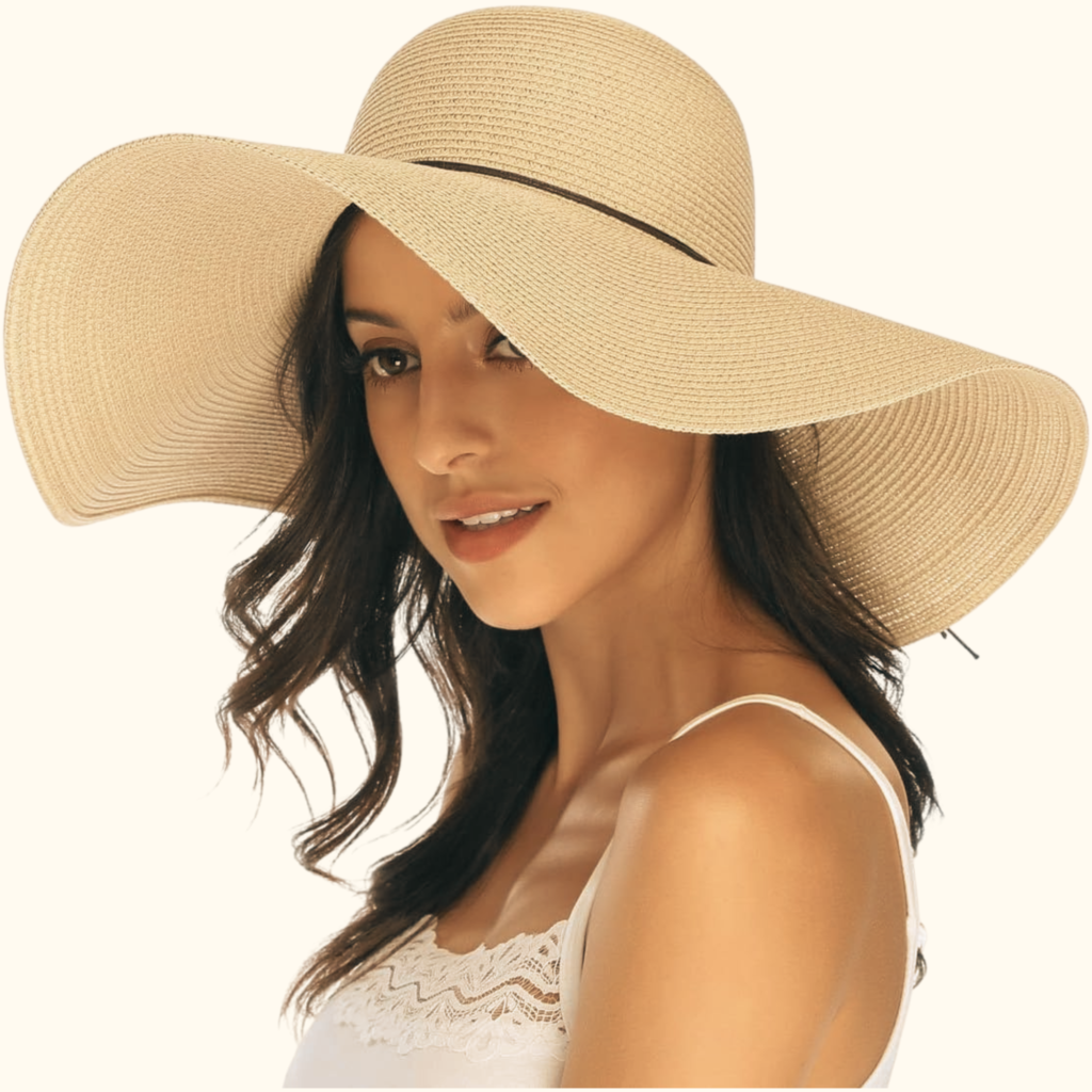 woman with dark long hair wearing a large floppy beige sun hat