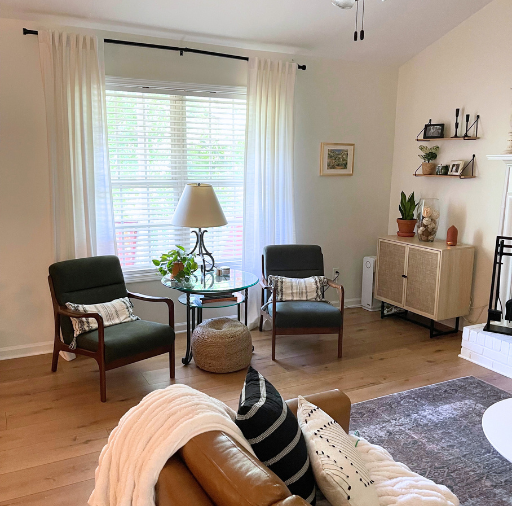 living room view of window and green chairs