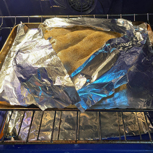 pie in th eoven with foil covering the crust