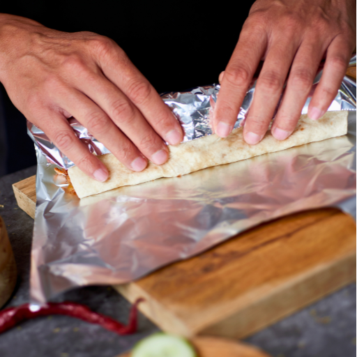 wrapping a flour tortilla into a burrito