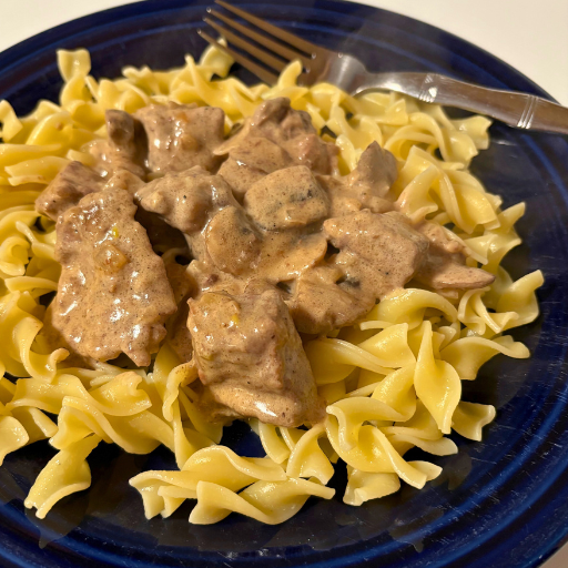 beef stroganoff on a blue plate