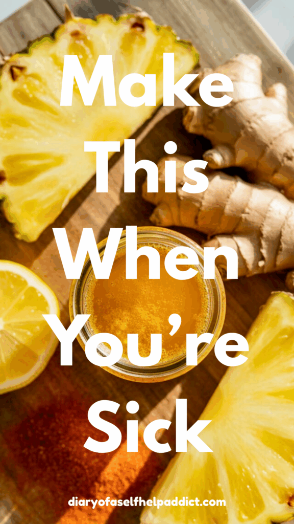 Bright yellow pineapple chunks, fresh ginger root, a lemon half, and a sprinkle of cayenne surrounding a small glass jar of the blended tonic. Rustic cutting board, overhead shot, vibrant wellness colors.