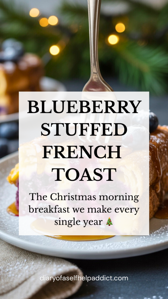 A plated slice of blueberry cream cheese French toast drizzled with maple syrup, fork cutting into the soft custardy layers, blueberries bursting, neutral linen napkin, pine greenery and twinkle lights softly blurred in the background.