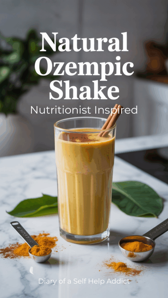 A tall glass of a turmeric-gold, cinnamon-speckled protein shake on a white marble countertop with green tea leaves and measuring spoons around it, soft natural lighting, minimalist wellness vibe, clean modern fonts reading ‘Natural Ozempic Shake’ on top