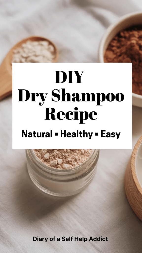 A minimalist flat lay of a small glass jar filled with beige powder dry shampoo, surrounded by arrowroot powder in a wooden spoon, cocoa powder in a bowl, and soft natural lighting on a white linen background.