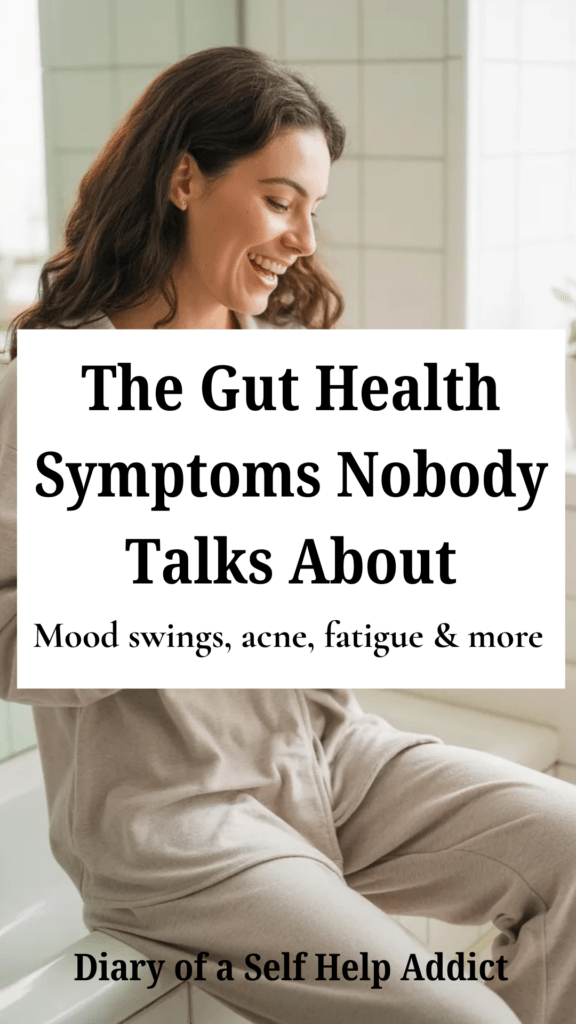 A bright, clean bathroom scene with a woman in cozy neutral loungewear holding coffee and laughing while reading about gut health on her phone. Soft natural lighting, spa-like aesthetic, minimal decor, wellness influencer vibe.