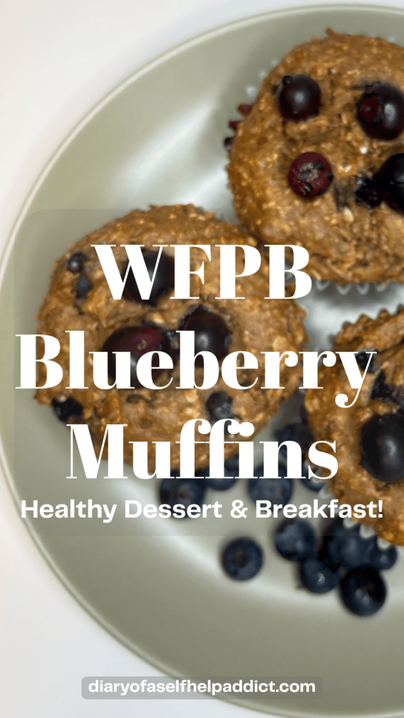 whole food plant based blueberry muffins on a plate surrounded by fresh blueberries.