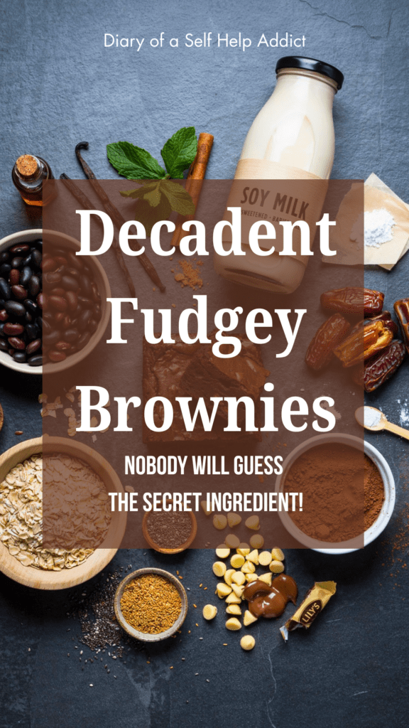 Ingredients beautifully arranged flat lay style: black beans, dates, soy milk, rolled oats, cocoa powder, flaxseed, chia seeds, vanilla, baking powder, Lily's chocolate chips, and a sliced brownie in the center.