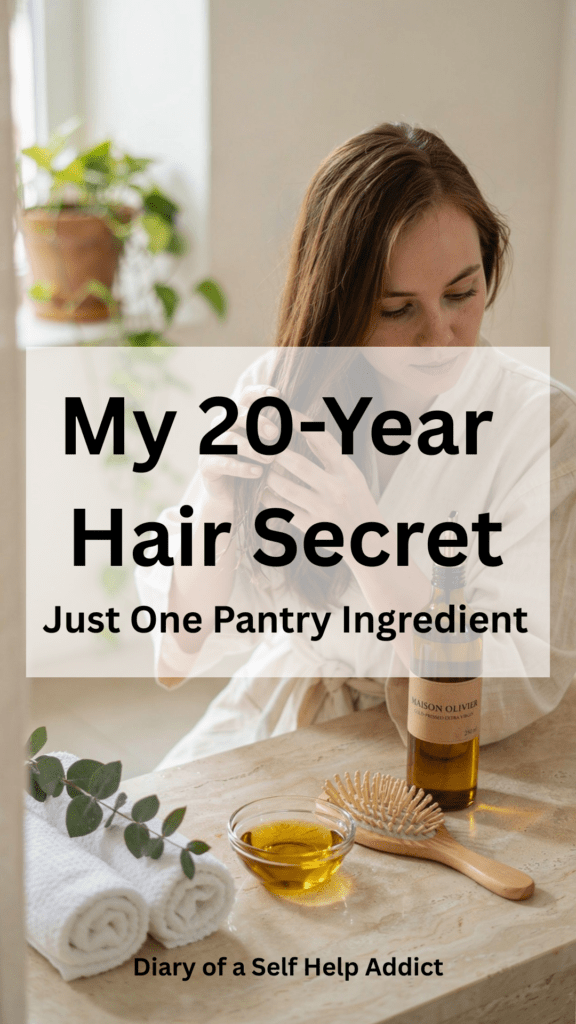 A spa-inspired bathroom scene with a bottle of olive oil beside a wooden hairbrush, rolled white towels, fresh eucalyptus, a small glass bowl of olive oil, and a woman applying olive oil to the ends of her long healthy hair in soft natural lighting.