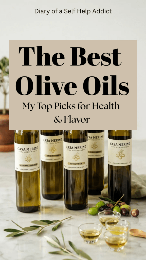 Five elegant bottles of premium extra virgin olive oil displayed on a white marble countertop beside fresh olives, olive branches, small tasting cups, and labels reading "High Polyphenols," "Cold Pressed," and "Extra Virgin," creating the feel of a gourmet olive oil tasting.