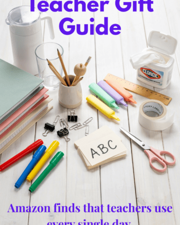 An aesthetically pleasing collection of classroom essentials neatly arranged on a white wood background including disinfecting wipes, water pitcher, binders, highlighters, flash cards, labels, markers, scissors, and office supplies. Bright, clean, Pinterest-worthy style.
