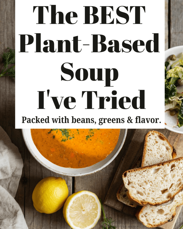 A rustic white bowl filled with creamy lemony chickpea soup topped with fresh dill, cracked black pepper, and a drizzle of extra virgin olive oil. Served with slices of homemade sourdough bread and a crisp kale and cabbage salad on a wooden table with fresh lemons and herbs nearby.