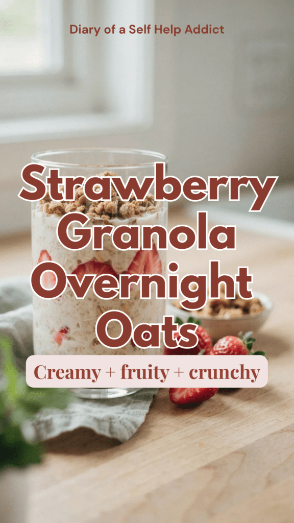 Creamy overnight oats layered in a clear glass jar with sliced fresh strawberries and topped with crunchy golden granola. Additional strawberries scattered nearby with a small bowl of granola in the background. Bright, colorful, fresh morning light with a casual homemade feel.