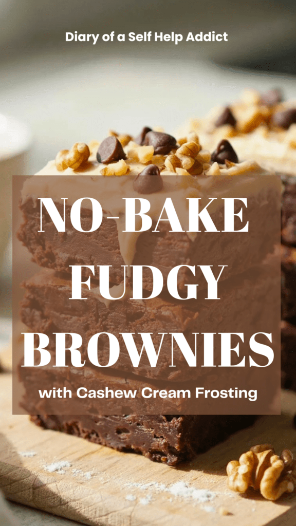 Close-up angled photograph of several stacked no-bake brownies with a thick layer of creamy cashew frosting. One brownie is cut open to show the dense, fudgy chocolate center. Sprinkle a few chopped walnuts and mini chocolate chips over the top. Soft natural light, shallow depth of field, cozy homemade dessert aesthetic.
