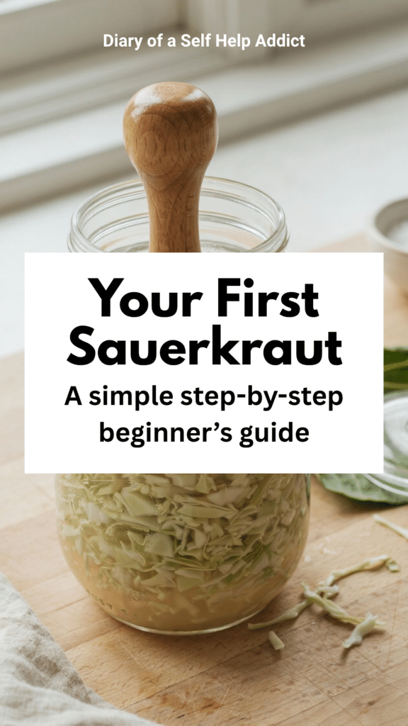 A detailed photograph of shredded cabbage being firmly packed into a wide-mouth Mason jar with a wooden fermentation tamper. The cabbage’s natural brine is visible rising in the jar. Beside it, show a reserved cabbage leaf ready to be placed over the shreds, plus a fermentation lid. Fresh, crisp greens and warm neutral colors; educational but still pretty enough for Pinterest.