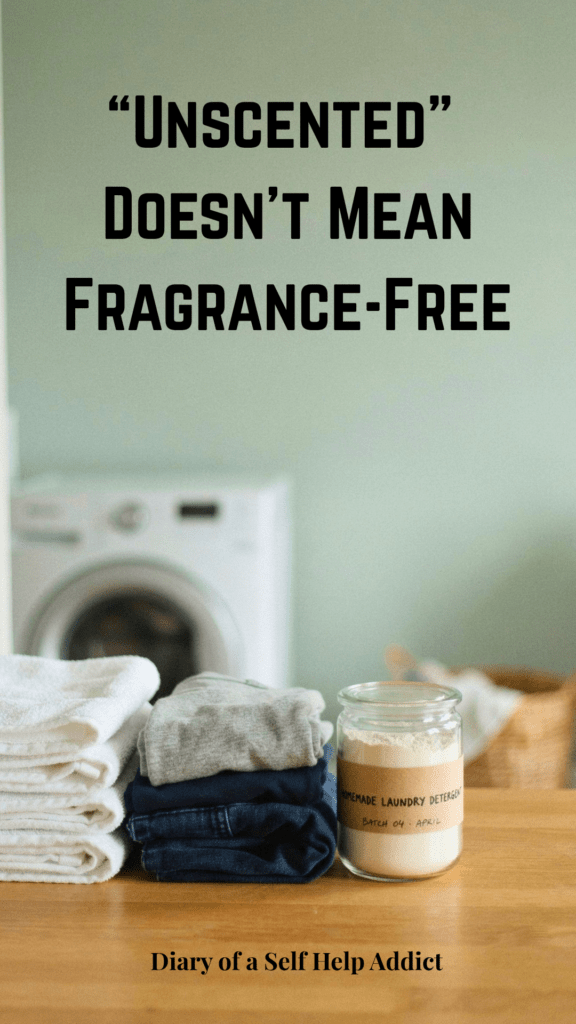 Freshly folded towels and clothing beside a simple container of homemade laundry detergent in a bright laundry-room setting. Clean and realistic, without flowers or overly staged decor.