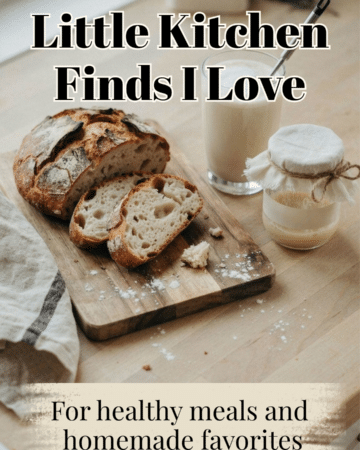 A rustic sourdough loaf with several slices on a wooden board beside a creamy coffee and handheld electric whisk. Include a starter jar and folded linen towel. Warm, casual, and inviting. Optional text: “Little Kitchen Finds I Love.”