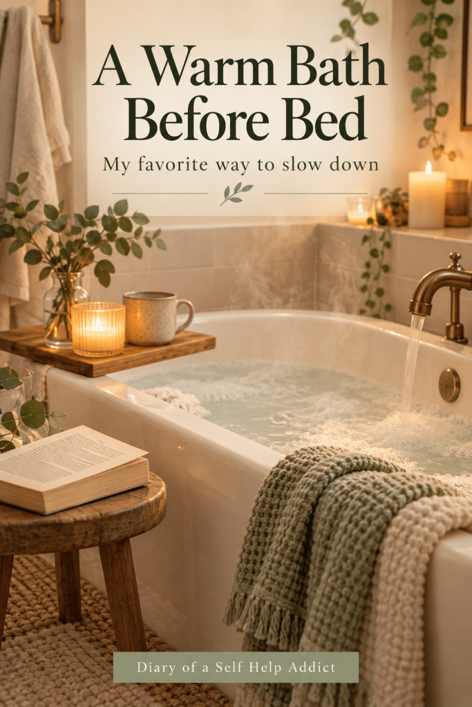 Create a vertical 2:3 Pinterest pin for a personal wellness blog. Feature a relaxing, warm bath in a clean, uncluttered bathroom with folded towels, a candle, a book nearby, and soft steam. Use warm white, pale beige, muted sage, and a hint of lavender. The mood should feel attainable and cozy, not like a luxury spa advertisement. Avoid medical imagery, detox claims, or product labels. Add large readable text: “A Warm Bath Is My Favorite Way to Wind Down.” Small subtext: “One simple part of my nighttime routine.” Add “Diary of a Self Help Addict” at the bottom.